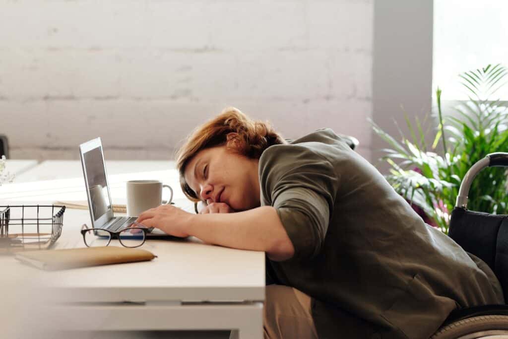 unproductive woman sleeping at desk